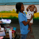 Filipina Flor, 20, holds her son Vincent as she tries to sell souvenirs along the Pope Francis motorcade route in Manila, Philippines, Thursday, Jan. 15, 2015.